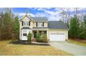 Inviting two-story home featuring a covered porch, bay window, and a two-car garage at 1226 Woodland Church Rd, Wake Forest, NC 27587