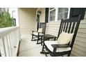 Inviting front porch featuring rocking chairs and white trim at 1226 Woodland Church Rd, Wake Forest, NC 27587