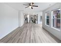 Open concept living room features large windows, light gray flooring, and flows into the kitchen at 1336 Weavers Trace Dr, Zebulon, NC 27597