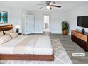The main bedroom features a ceiling fan, ensuite, and neutral decor at 1336 Weavers Trace Dr, Zebulon, NC 27597