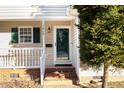 Close-up of the front entryway with a brick porch and white railing at 1614 W Cotton Gin Dr, Clayton, NC 27527