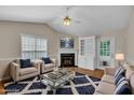 Cozy living room with vaulted ceilings, fireplace, and comfortable seating at 1614 W Cotton Gin Dr, Clayton, NC 27527