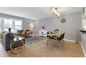 Open-concept living and dining area with stylish furniture and an abundance of natural light at 174 St. Andrews Ln, Chapel Hill, NC 27517