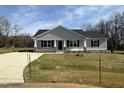 Picture of a charming single-story home with well-manicured lawn and an inviting front porch at 197 Pate Landing Dr, Selma, NC 27576