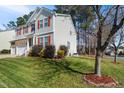 Beautifully landscaped yard with flowering shrubs enhances this two-story home at 211 Whitney Ln, Durham, NC 27713