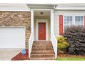 Inviting brick steps lead to the front door and covered porch entrance at 211 Whitney Ln, Durham, NC 27713