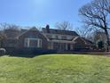 Back exterior view of the house showing a brick exterior, patio, and lawn at 30 Brookside Place, Durham, NC 27705