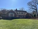 Stunning brick home with manicured lawn, large windows, and architectural details at 30 Brookside Place, Durham, NC 27705
