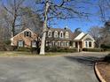 Attractive brick home with black shutters, dormer windows, and well-maintained landscaping at 30 Brookside Place, Durham, NC 27705