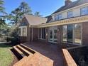 Beautiful brick home featuring a brick patio, glass windows, and well-maintained backyard at 30 Brookside Place, Durham, NC 27705