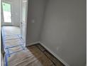 Bright entryway featuring light walls, a door, and flooring covered in protective material at 332 Chesapeak Commons St # 141, Garner, NC 27529