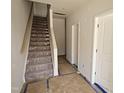 New home construction with an interior staircase featuring wood handrail and steps covered for protection at 332 Chesapeak Commons St # 141, Garner, NC 27529