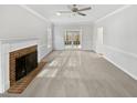 Spacious living room featuring a brick fireplace, a ceiling fan, and neutral colors at 4016 Ridgebrook Bluffs Dr, Raleigh, NC 27603