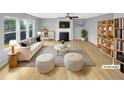 Bright, staged living room featuring a fireplace, modern furnishings, and plenty of natural light at 405 Ganyard Farm Way, Durham, NC 27703