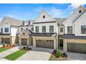 Attractive townhome with two-car garage, brick accents, and landscaping, offering curb appeal at 46 N District Ave # 251, Clayton, NC 27527