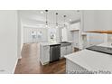 Bright, open kitchen featuring an island, stainless steel appliances, and modern finishes at 46 N District Ave # 251, Clayton, NC 27527