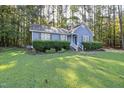 Charming blue home with a well-manicured front lawn and lush green landscaping at 5108 Walton Hill Rd, Knightdale, NC 27545