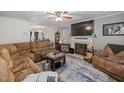 Spacious living room with fireplace, large TV, and access to the dining area at 5108 Walton Hill Rd, Knightdale, NC 27545