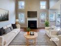 Bright living room with fireplace, hardwood floors, and abundant natural light at 5317 Tifton Dr, Raleigh, NC 27610