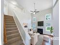 Bright living room with soaring ceilings, a fireplace, large windows, and elegant furnishings at 5317 Tifton Dr, Raleigh, NC 27610