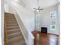 Bright living room with soaring ceilings and fireplace; stairs lead to upper level at 5317 Tifton Dr, Raleigh, NC 27610