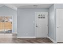 Bright entryway with light blue walls, white trim, and stylish herringbone floors at 605 Stratton Way, Durham, NC 27704