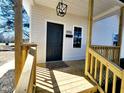 A welcoming porch featuring fresh wood and a modern light fixture at 606 E Pearsall St, Dunn, NC 28334