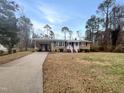 Well maintained front yard with charming brick home and covered carport at 623 Sybil Dr, Durham, NC 27703