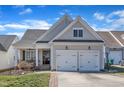 Charming home with a two-car garage, covered front porch, and a well-manicured lawn at 7025 Dayton Ridge Dr, Apex, NC 27539