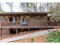 Inviting front entrance with a wooden deck, brick accents, and a landscaped walkway at 748 Shady Lawn Rd, Chapel Hill, NC 27514