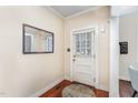 Inviting entryway with hardwood floors, mirror, and a traditional-style door at 816 Carolina Ave, Durham, NC 27705