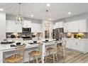 Bright, spacious kitchen featuring an island with seating and stainless steel appliances at 206 Faith Ave, Sanford, NC 27330