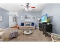 Cozy living room with neutral tones, comfortable seating, and a ceiling fan for added comfort at 107 Vickery Hill Ct, Durham, NC 27703