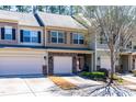 Attractive townhomes featuring stone accents and well-maintained landscaping in a quiet neighborhood at 107 Vickery Hill Ct, Durham, NC 27703
