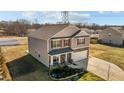 A two-story home with a well-manicured lawn, stone accents, and a two-car garage at 110 Lodgepole Ln, Burlington, NC 27215