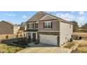 A stylish home with a two-car garage, stone accents and a well-kept lawn at 110 Lodgepole Ln, Burlington, NC 27215