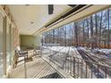 Covered back porch overlooking the backyard with metal railing and ceiling fan at 11408 Hickory Grove Church Rd, Raleigh, NC 27613