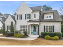 Inviting two-story home featuring painted brick, a covered entryway, and manicured landscaping at 1301 Mackinaw Dr, Wake Forest, NC 27587