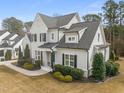 Beautiful two-story home featuring painted brick, manicured landscaping and a welcoming entrance at 1301 Mackinaw Dr, Wake Forest, NC 27587