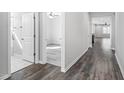 Hallway featuring modern flooring leading to the bedrooms and bathroom with a ceiling fan at 138 Clear Water Rd, Louisburg, NC 27549