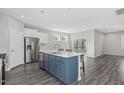 Open-concept kitchen featuring an island with bar seating, stainless steel appliances, and modern finishes at 138 Clear Water Rd, Louisburg, NC 27549