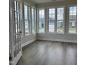 Charming sunroom with hardwood floors and large windows providing great neighborhood views at 138 Oban Dr, Homesite 134, Sanford, NC 27330