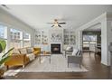 Inviting living room with a fireplace, built-in shelving, and lots of natural light at 140 Southern Acres Dr, Fuquay Varina, NC 27526