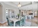 This open-concept dining room and kitchen features ample space for entertaining guests at 142 Oban Dr, Homesite 135, Sanford, NC 27330