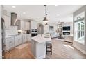 Modern kitchen with stainless steel appliances, herringbone backsplash, and large island at 142 Oban Dr, Homesite 135, Sanford, NC 27330