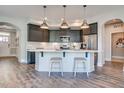 Kitchen features stainless steel appliances, gray cabinets, an island with pendant lights, and white countertop at 142 Oban Dr, Homesite 135, Sanford, NC 27330