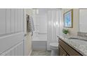 Well-lit bathroom featuring a shower-tub combo and a vanity with a granite countertop at 1435 Monterey Bay Dr, Wake Forest, NC 27587