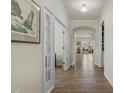 Inviting hallway features hardwood floors, stylish doors, and an arched opening to the living area at 1435 Monterey Bay Dr, Wake Forest, NC 27587