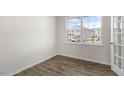 Bright room with luxury vinyl plank flooring, a large window, and white trim at 173 Paper Birch Way, Fuquay Varina, NC 27526