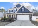 Traditional home with a two-car garage, blue and gray accents, and a welcoming front porch at 192 Springhill Ln, Garner, NC 27529